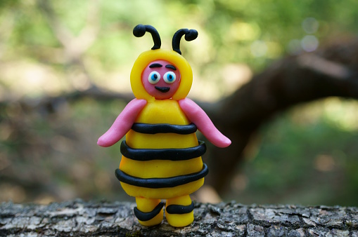 Photo of a toy bee made of plasticine.