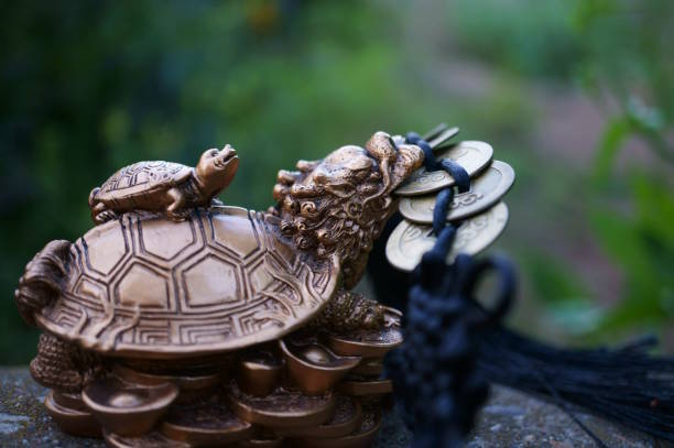 istock Dragon turtle figurine with Chinese coins. 1741178573