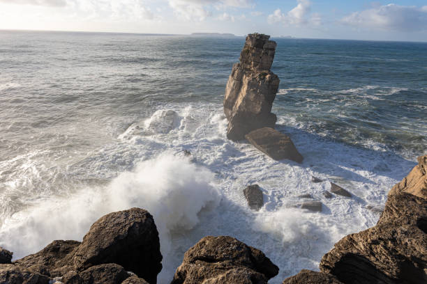 istock Big sea waves crash against the rocks - wallpaper 1741182476