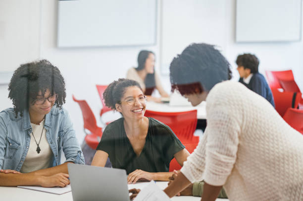 istock Teacher helping University Students in Classroom 1741187435