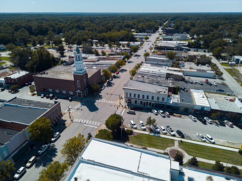 Camden Clock Tower on street corner of Camden, SC. Broad Street intersection, full of cafes and shops leading to the horizon in Camden, South Carolina