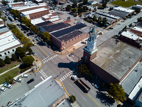 Rare traffic on the road junction in Camden, SC. Camden Clock Tower on Broad Street intersection in South Carolina. Aerial cityscape view