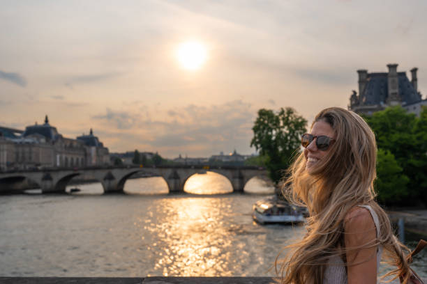 istock Blonde woman walking along a river in Paris 1741225694