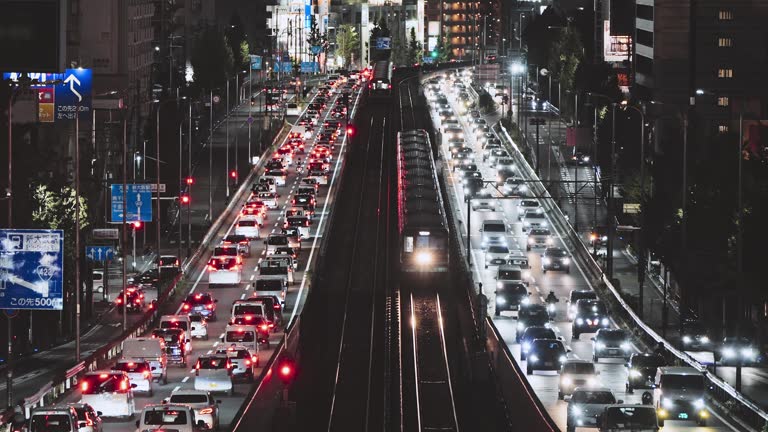 Car traffic transportation on elevated highway road, commuter subway train on railroad track at night in Japan. Japanese people lifestyle, Asia transport culture, Asian city life concept