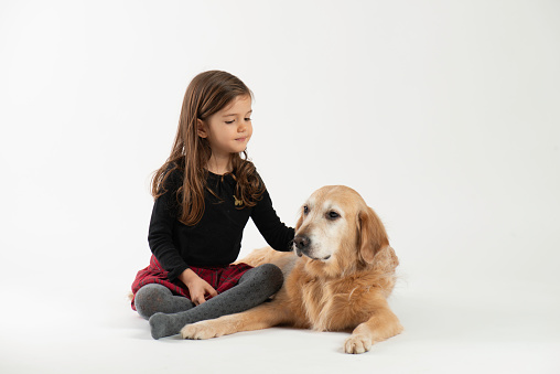 Little girl and dog over the white background.