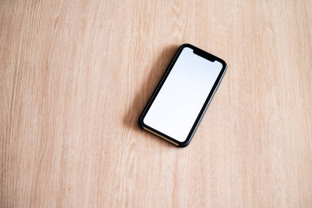 istock Smartphone. Telephone. Mobile phone. Screen. White screen. Smartphone screen. Phone screen. The phone is on the table. Black phone. Distant work 1741240985