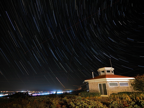 Night sky star trails on dune bluff at Cape Cod National Seashore in Truro Massachusetts