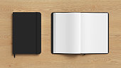Black cover notebook and opened notebook mockup on wooden background