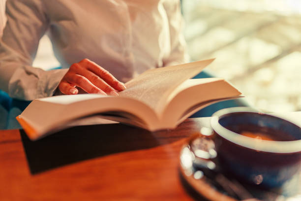 istock Reading A Book At Coffee Shop 1741306219