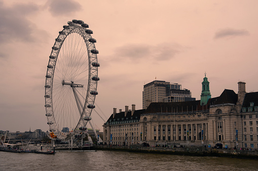 London, United Kingdom - April 5, 2023: View of the south bank with the London Eye ferris wheel in the background.