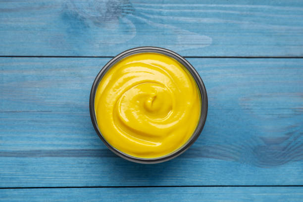 istock Sauce bowl with delicious mustard on light blue wooden table, top view 1741323627