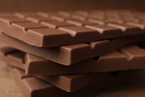 istock Tasty chocolate bars on wooden table, closeup 1741327537