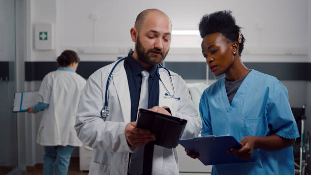 istock Practitioner doctor with black assistant checking recovery treatment 1741344877