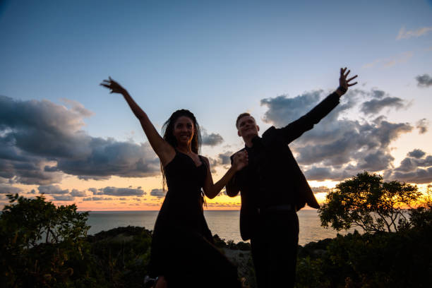 istock Happy young couple backlit against sunset background 1741348298