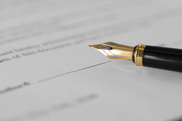 istock Fountain pen on document with place for signature, closeup and space for text. Notary contract 1741387044