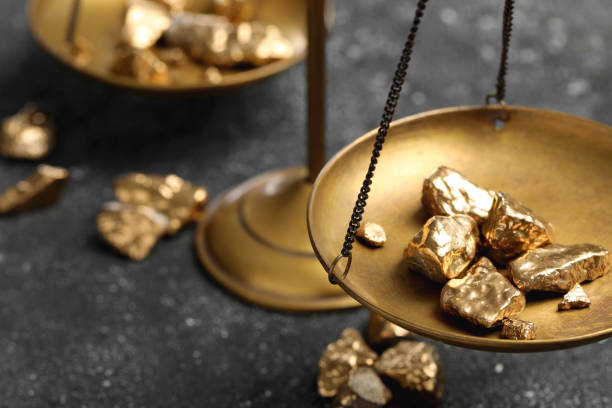 istock Vintage scales with gold nuggets on grey table, closeup. Space for text 1741387629