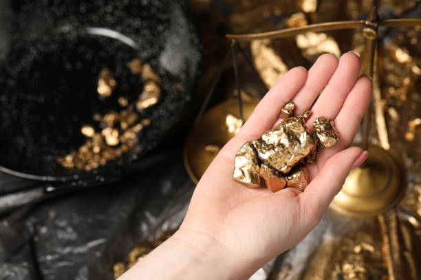 istock Woman with gold nuggets, closeup. Space for text 1741387649