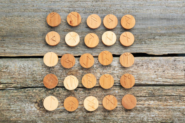 istock Runes with different symbols on wooden table, flat lay 1741395640