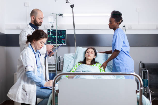 istock Practitioner doctors monitoring disease symptom writing recovery treatment 1741397931