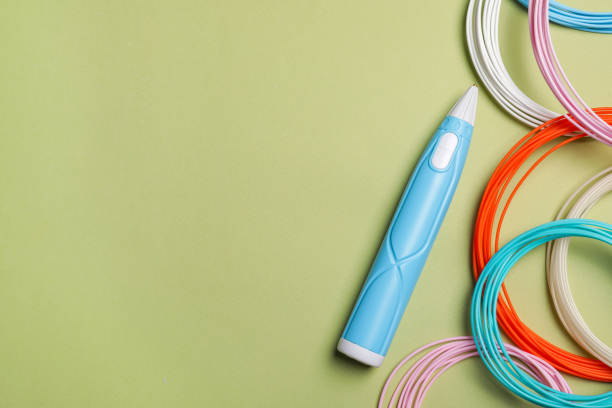 istock Stylish 3D pen and colorful plastic filaments on olive background, flat lay. Space for text 1741407409