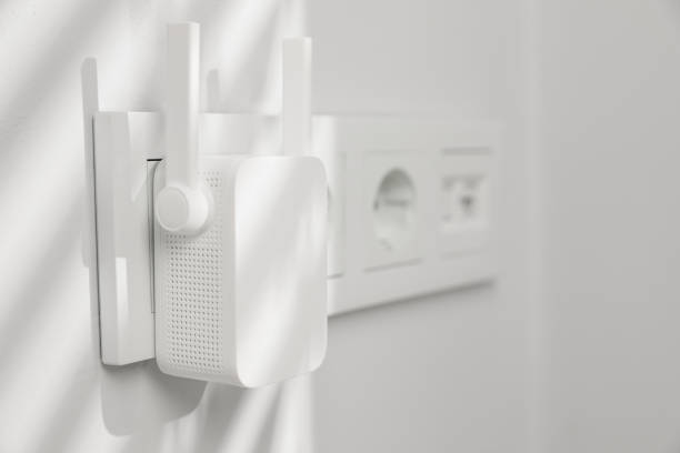 istock Wireless Wi-Fi repeater on white wall indoors, space for text 1741407454