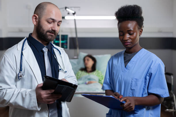 istock Medic and nurse comparing lab results using digital tablet with patients medical chart on clipboard 1741414035