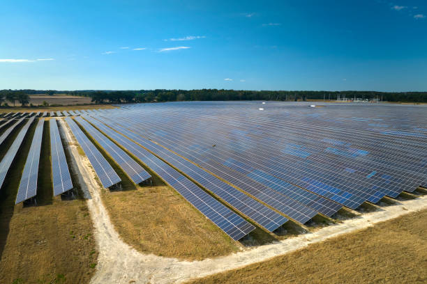 Aerial view of large sustainable electrical power plant with rows of solar photovoltaic panels for producing clean electric energy. Concept of renewable electricity with zero emission Aerial view of large sustainable electrical power plant with rows of solar photovoltaic panels for producing clean electric energy. Concept of renewable electricity with zero emission. manufacturing sourcing stock pictures, royalty-free photos & images