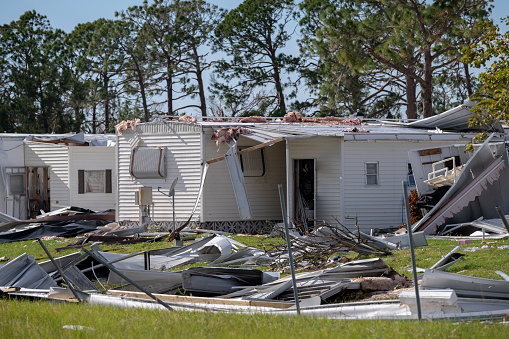 Destroyed by hurricane suburban houses in Florida mobile home residential area. Consequences of natural disaster.