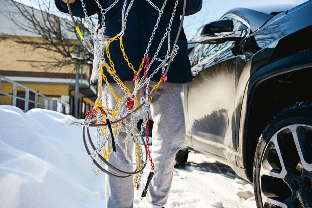 man is installing snow chains. man is installing snow chains. slippery unrecognizable person safety outdoors stock pictures, royalty-free photos & images