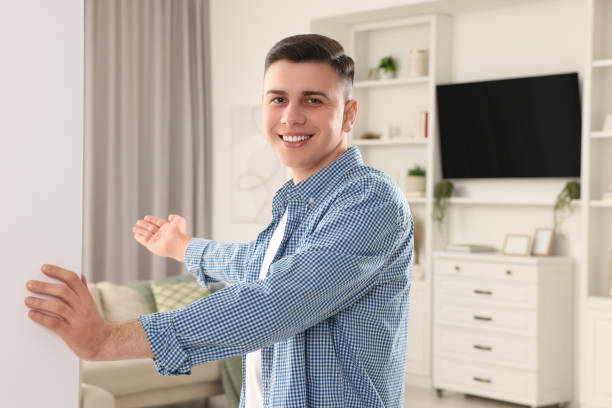 istock Handsome man inviting to come in room at home 1741436042