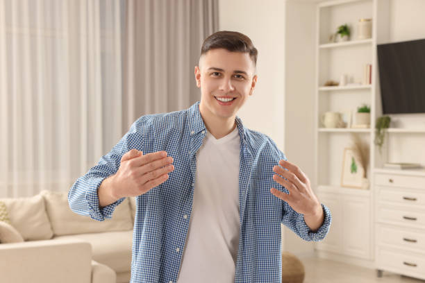 istock Handsome man inviting to come in room at home 1741436611