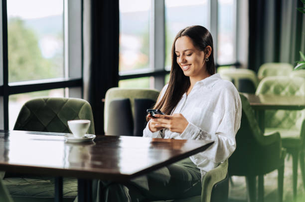 istock A cheerful young woman is hanging on social media while having a coffee 1741449771