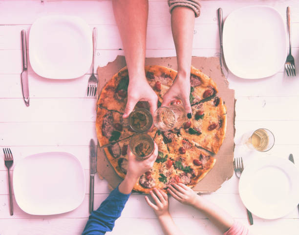 istock family clank glasses together having a dinner with pizza 1741449799