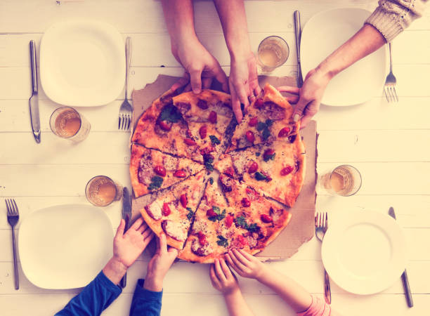 istock hands taking pieces of pizza 1741449801