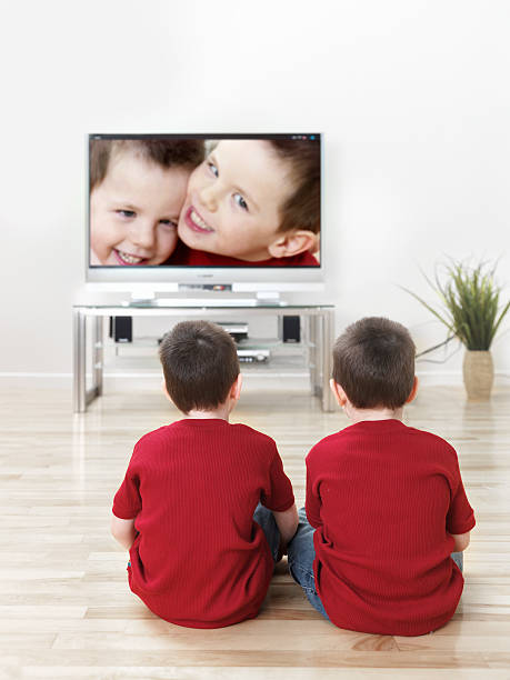 istock Twin children watching TV 174144997