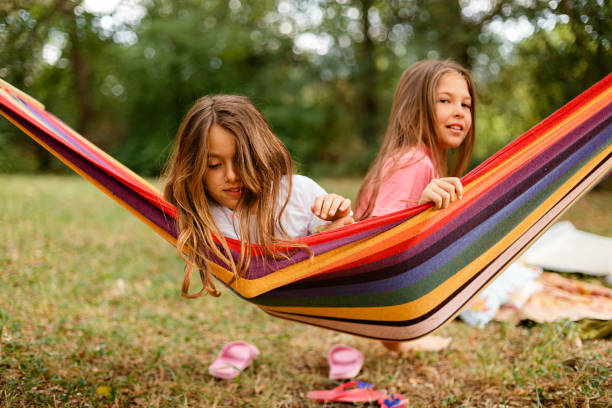 istock Two Girls enjoys while resting in the hammock in the yard 1741451892