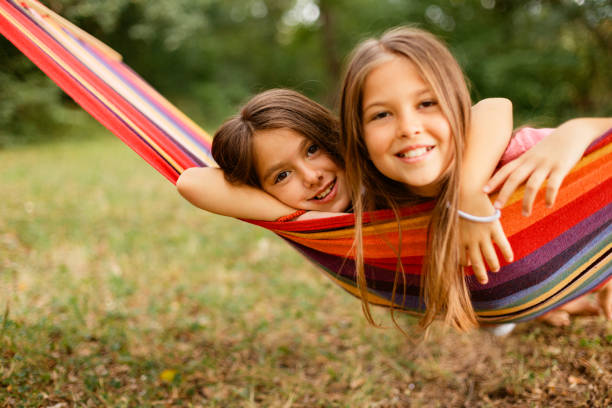 istock Two Girls enjoys while resting in the hammock in the yard 1741452402