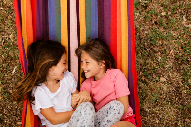istock Girls having fun lying in hammock in the yard 1741456565