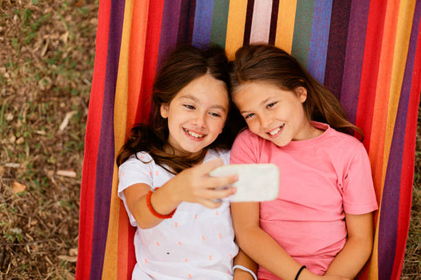 istock Girls taking selfie while lying in the hammock 1741457117