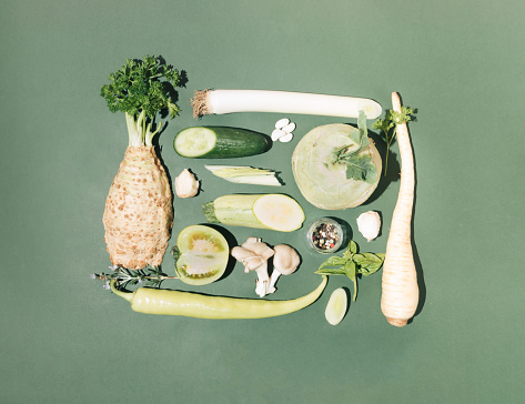Creative arrangement of healthy organic food in shades of green color. Flat lay frame