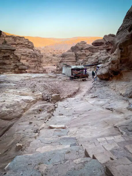 Ad-Deir Trail Monastery Route with bedouin stall in the historic and archaeological city of Petra, Jordan against blue sky at sunset
