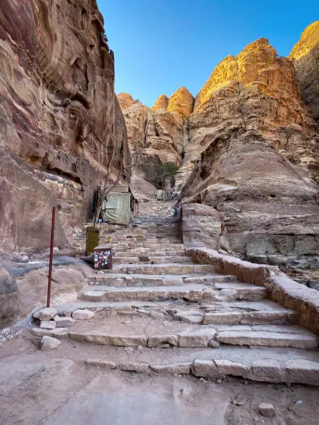Stairs in the rock along Ad-Deir Trail Monastery Route in the historic and archaeological city of Petra, Jordan against sky