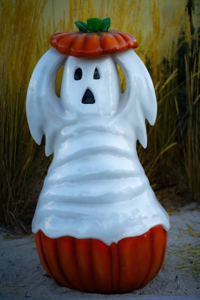 istock Vertical of a ghost and pumpkin decoration for Halloween 1741518398