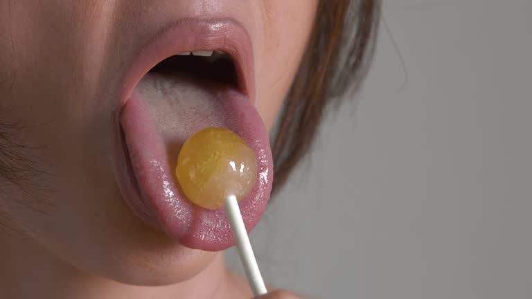 Woman licking lollipop