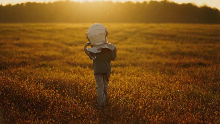 Fantasy And Dream About Travel In Space, Little Boy In Space Helmet Walking Alone In Lawn