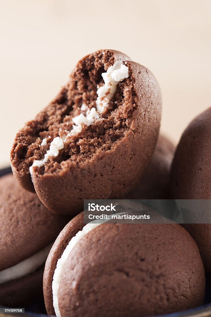 Bitten chocolate and vanilla whoopie Chocolate and vanilla whoopie in a pile close-up Sweet Pie Stock Photo
