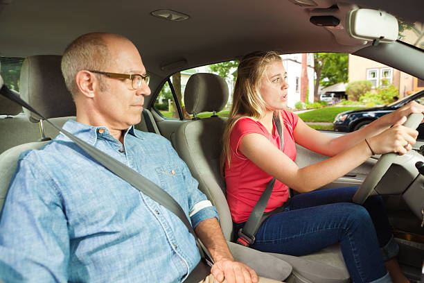 istock Teenage Driver Learning to Drive with Parent or Driving Instructor 174159731