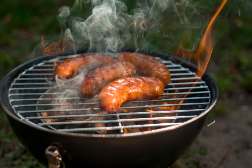 sausages on the grill with smoke