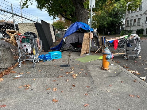 A homeless camp tent on a city sidewalk