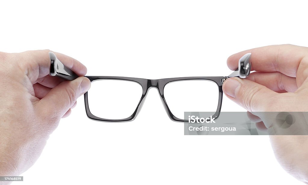 Man wearing glasses to improve vision. On a white background. A man wearing glasses to improve vision. On a white background. Analyzing Stock Photo